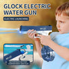 A boy is holding a blue electric water gun, demonstrating its electric launching feature against a blurred outdoor background