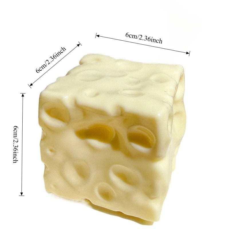 A pale yellow squishy cheese cube stress ball with visible indentations, measuring 6cm/2.36inch.
