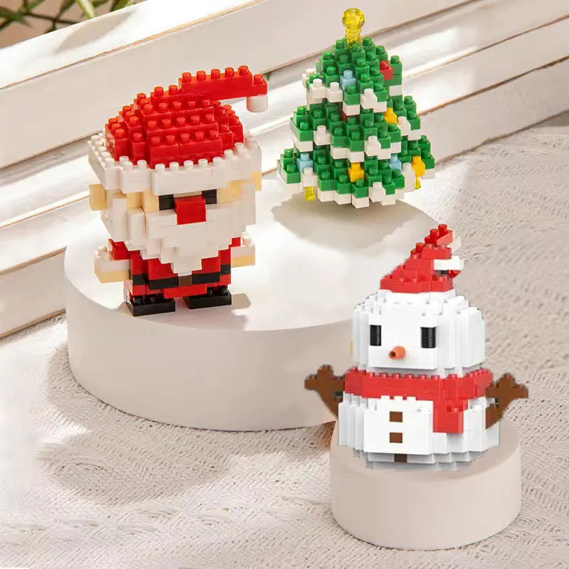 A set of Christmas micro building blocks featuring Santa and a reindeer on a white display base.