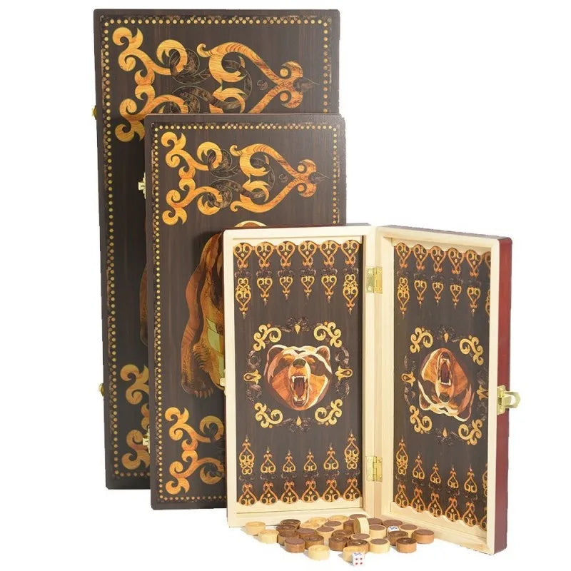A set of folding wooden chess and checkers game boards with ornate gold detailing and wooden pieces.