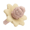 Silicone teething toys shaped like a flower and grape in soft pink and cream colors.