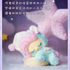 A soft blue and pink My Little Pony figure with a light purple mane is displayed against a lavender background.