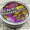 A tin of Camo Masking Putty with a camouflage pattern and the text Blue Queen Color