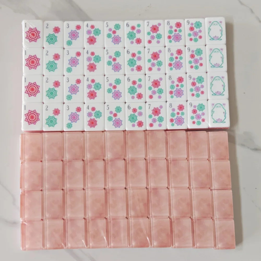 A set of pearl pink acrylic American Mahjong tiles arranged in two rows.