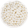 A pile of small, round ivory pearl beads for DIY jewelry making.