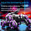 A close-up of a black and purple transformable RC stunt tank with articulated arms resting on a blue surface.
