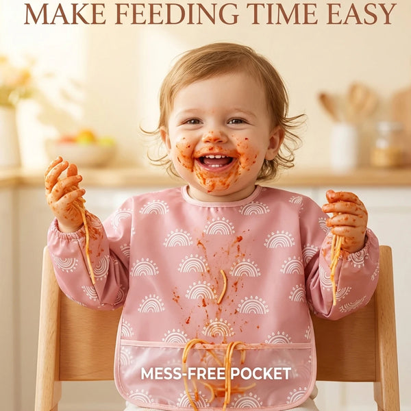 A smiling baby wearing a pink bib with a mess-free pocket, demonstrating easy feeding.