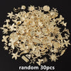 A pile of random gold-colored metal charms for DIY jewelry making