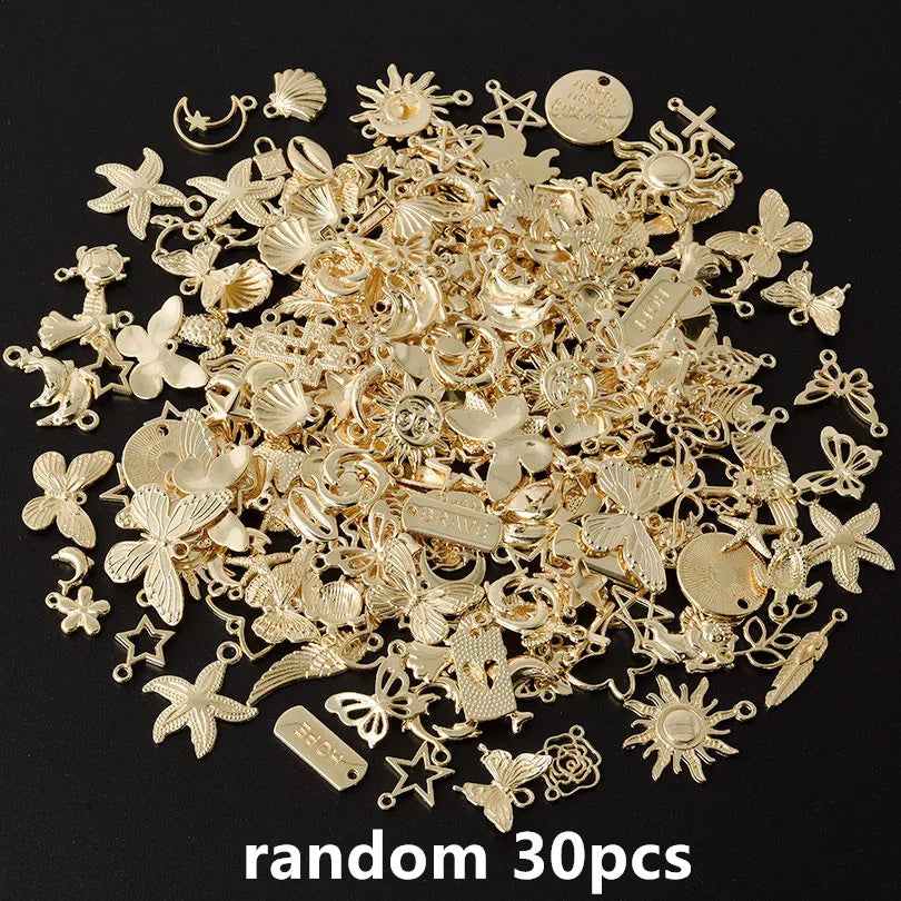 A pile of random gold-colored metal charms for DIY jewelry making