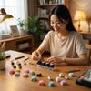 A woman is arranging colorful LED light-up keycaps on a wooden table.