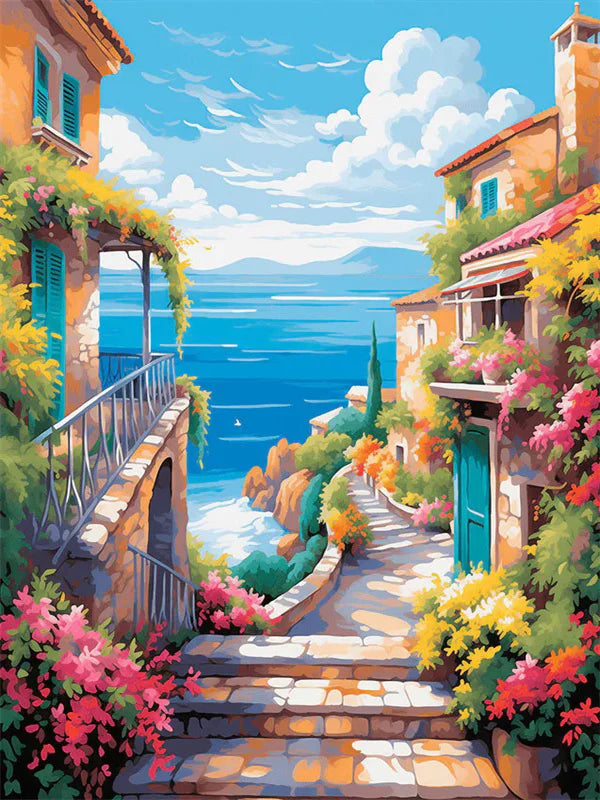 A vibrant painting of a Mediterranean-style building with colorful flowers and a stone pathway overlooking the blue sea.