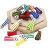 A collection of mixed color velvet tassels in various shades are displayed on a wooden surface.