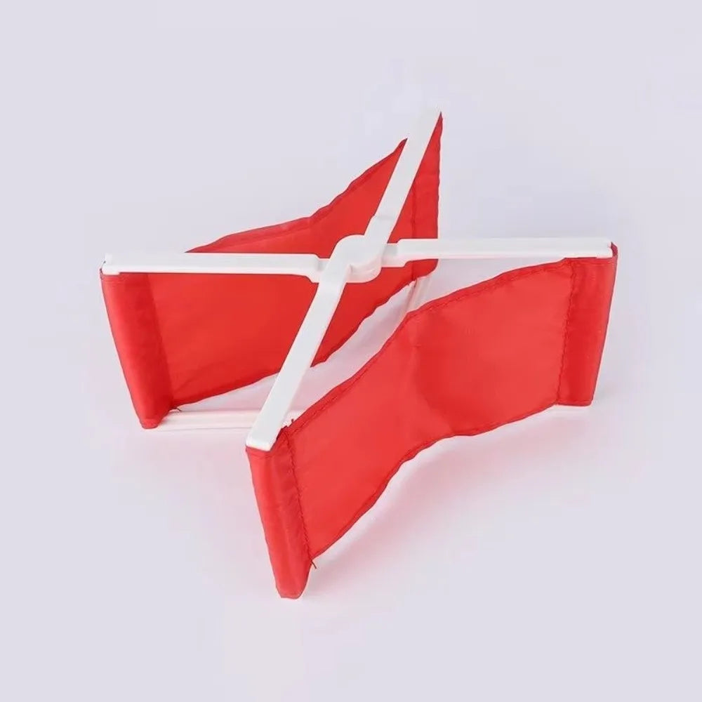 Red foldable camp pillow with a white strap, shown flat.