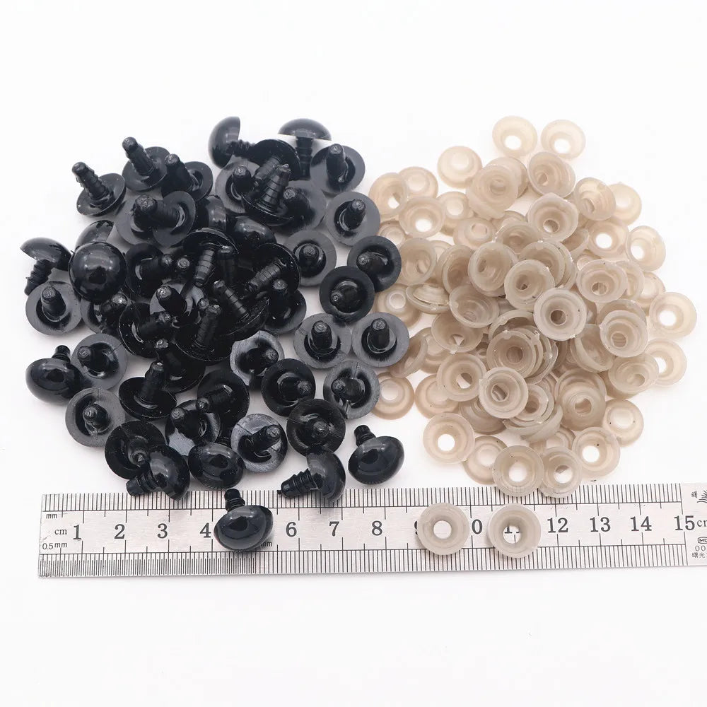 A collection of black and clear plastic safety eyes for amigurumi, including locking washers.