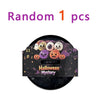 A set of Halloween squishy fidget toys including glitter pumpkin, eyeball, and skull stress relief balls in a black box.
