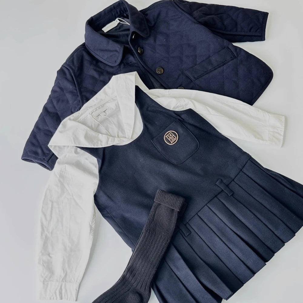 Navy knit sweater and pleated pants set for a toddler