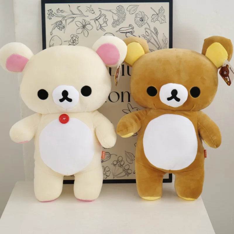 A plush toy of Rilakkuma in a strawberry bear design with light yellow fur and pink accents.