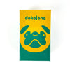 A yellow box labeled dokojong featuring a green stylized dog face.