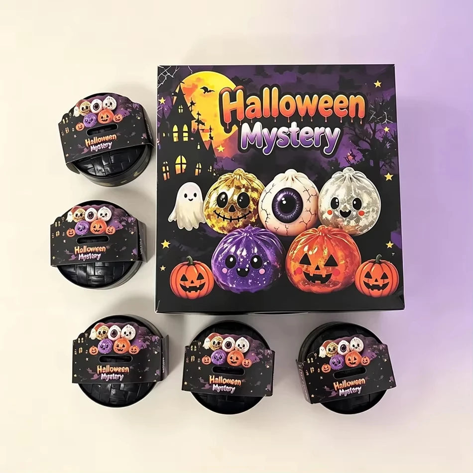 A set of Halloween mystery squishy fidget toys including glitter pumpkin, eyeball, and skull stress relief balls.