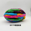 A ball of brightly colored chunky chenille yarn in various shades of green, purple, blue, and yellow.
