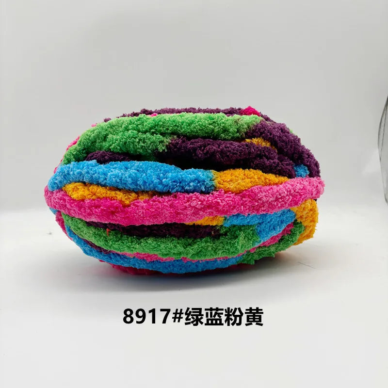 A ball of brightly colored chunky chenille yarn in various shades of green, purple, blue, and yellow.