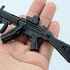 A black 1:6 scale MP5SD5 submachine gun model kit being held in a person's hand.