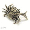 A brass figurine of a crab, resembling an animal desk statue.