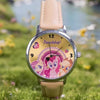 A pink My Little Pony themed watch with a light pink strap and a colorful face featuring pony characters.