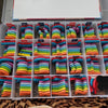 A plastic storage tray filled with colorful magnetic letters in various colors and shapes for educational learning.