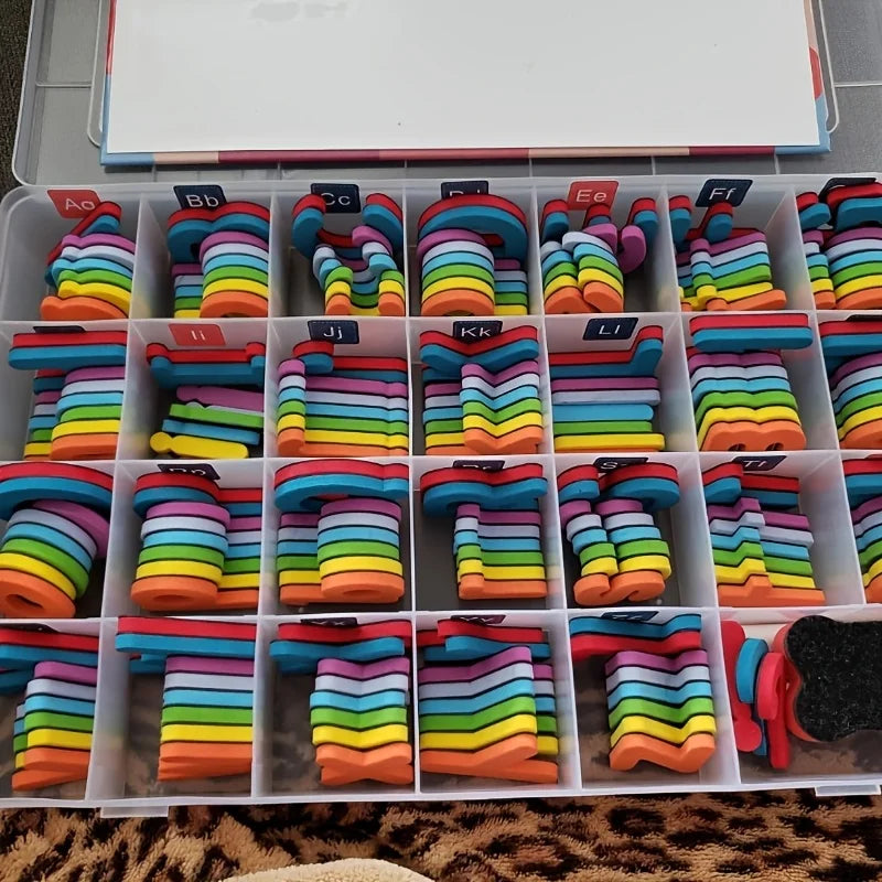 A plastic storage tray filled with colorful magnetic letters in various colors and shapes for educational learning.