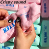 Hands squeezing a pink butter stick squishy stress ball with a crispy sound.