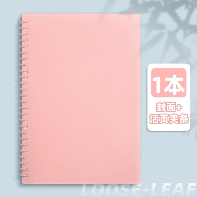 A pink spiral notebook with a cover featuring Japanese text indicating it includes a cover and historical content.