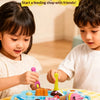 A set of strawberry pudding pretend play kitchen tools including spoons and molds for children.