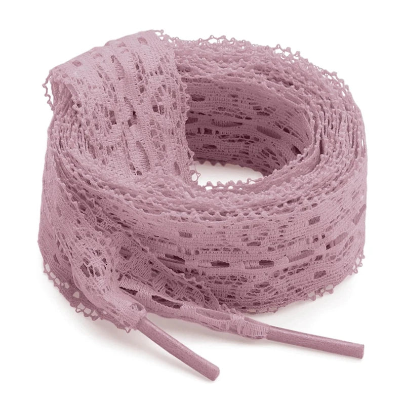 A roll of 3cm wide flat elastic silk lace shoelaces in a dusty mauve color.