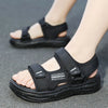 A pair of black Onedgeom summer sport sandals worn on a person's foot.