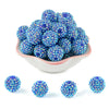 A pile of blue and purple rhinestone acrylic beads for jewelry making
