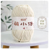 A ball of cream-colored chenille yarn labeled with Chinese characters for knitting and crochet.