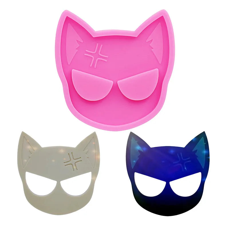 Three silicone cat head molds in pink, white, and blue for DIY keychains and craft projects