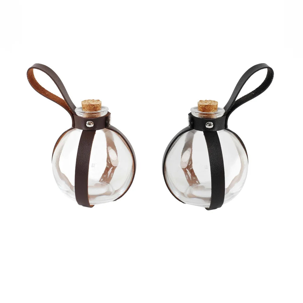 A clear glass potion bottle with a cork stopper and a black leather strap, used for cosplay.