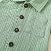 A light sage green linen shirt with buttons and a pocket.