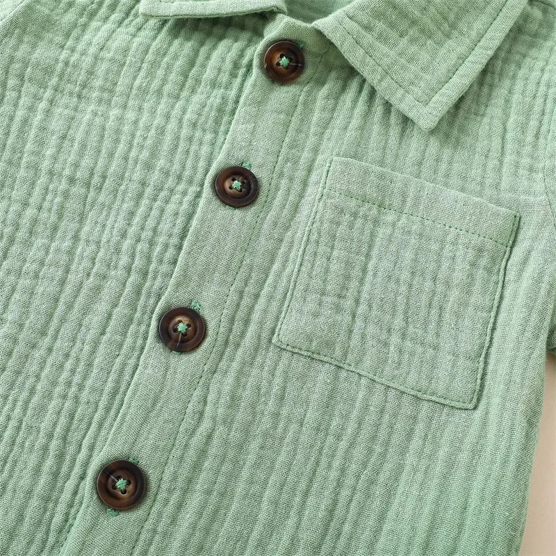 A light sage green linen shirt with buttons and a pocket.