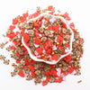 A pile of red and pink polymer clay sprinkles mix for slime decor and DIY craft accents.