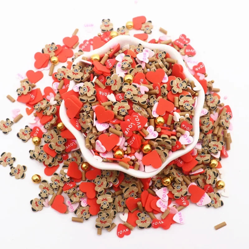 A pile of red and pink polymer clay sprinkles mix for slime decor and DIY craft accents.