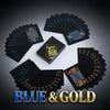 A stack of blue and gold playing cards, including a full deck and individual cards, displayed on a dark surface.