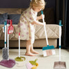 A young child is using a kids pretend play cleaning set with various tools and storage racks on a floor.
