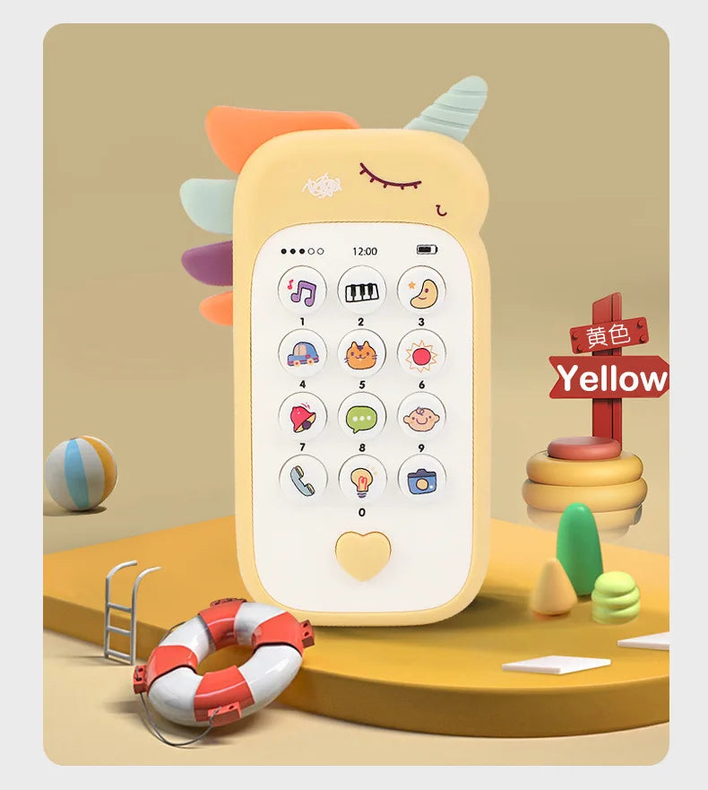 A yellow baby phone toy with a smiling face and various buttons, including music, sounds, and a teether attachment.
