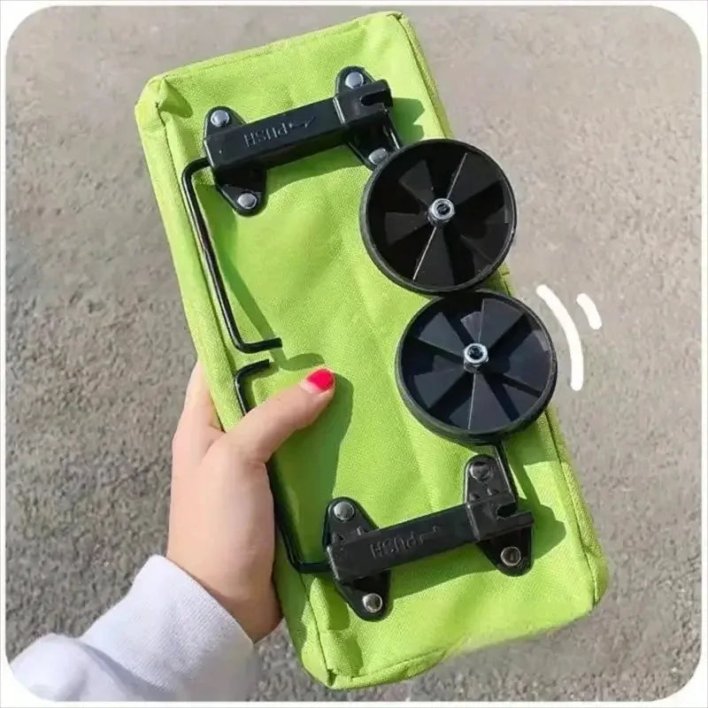A lime green foldable portable shopping cart with black backpack straps and wheels is held by a hand.