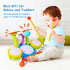 A toddler plays with an interactive kids drum set featuring light-up pads and a microphone.