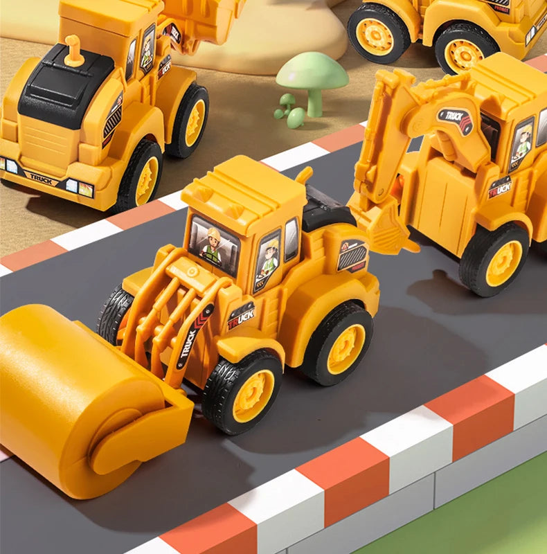Modèle de véhicule de construction en métal jaune avec un grand seau jaune et un bras d'excavatrice sur une surface grise.