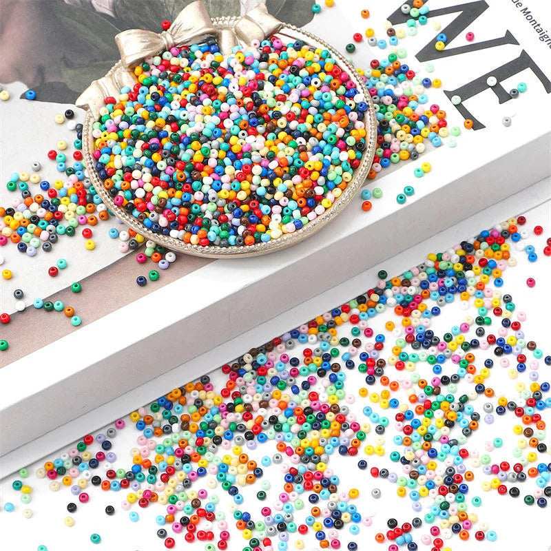 A close-up of a large, round container filled with a colorful mix of rainbow pony beads for jewelry making and craft projects